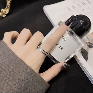Detailed view of a silver-toned minimalist ring with paved zircons on hand