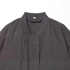 Women's dark gray oversized quilted bomber jacket with snap buttons and ribbed collar