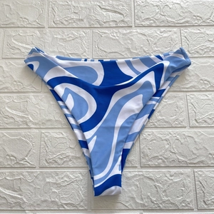 Detail of high-cut V-shaped bikini bottom featuring blue and white marble swirl patterns