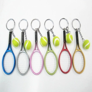 Close-up of six colorful metal tennis racket keychains with mini felt tennis balls