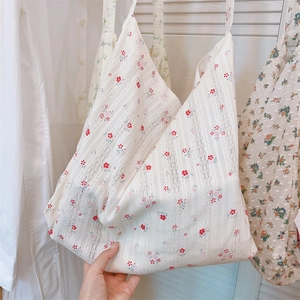 Detailed close-up of floral cotton lace tote bag with red and blue ink-wash patterns