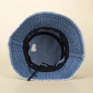 Distressed blue denim bucket hat with frayed edges, inner sweatband and adjustable drawstring