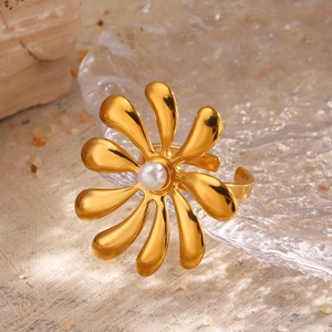 Vintage 18K gold plated flower ring with pearl inlay on a textured background