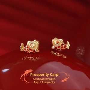 Macro detail of carp stud earrings with red enamel and gold finish for women
