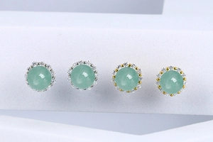 Macro view of gold and silver S925 earrings with green aventurine and pavé diamonds