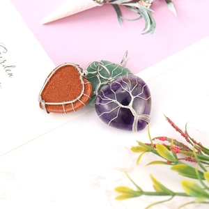 Detailed wire-wrapped heart pendants with life tree design in assorted natural stones