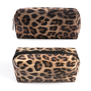 Macro shot of leopard print makeup bag with textured fabric and premium metal zipper