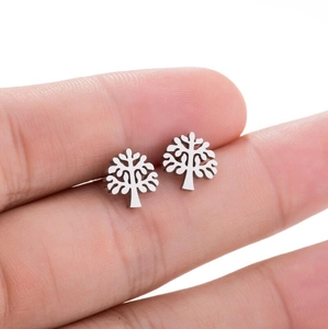 Minimalist silver tree of life stud earrings held by hand to show compact size