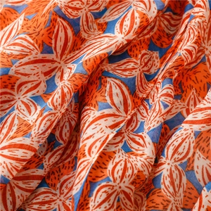 Detailed macro view of cotton linen scarf texture featuring abstract gardenia flower patterns