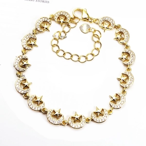 Detail of gold star and moon bracelet with micro-paved cubic zirconia stones