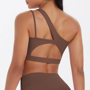 Rear view of brown yoga bra showing asymmetric single strap and back cutout detail