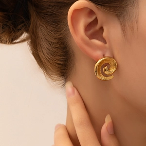 Detailed view of vintage gold twisted spiral earrings with matte brushed texture