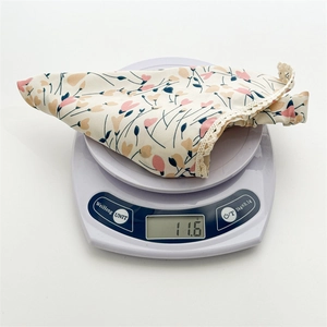 Floral print headscarf with lace trim on a scale weighing 11.6g for lightweight comfort