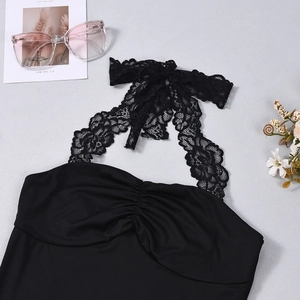 Detailed close-up of a black lace halter top with pleated chest design and tie-back details