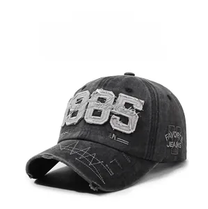 Detailed view of the 1985 embroidery and distressed denim texture on the baseball cap