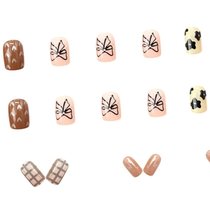 Short cow print press-on nails with 3D bows and heart patterns in a Korean style set