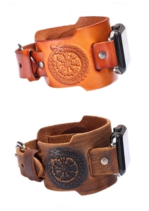 Detail of Viking compass dragon totem embossed on light and dark brown leather watch straps