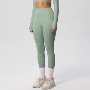 Close-up of mint green high-waisted yoga pants with functional side pockets