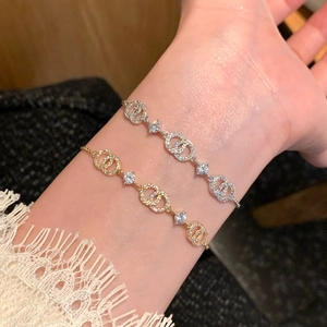 Close-up of elegant 18k gold and silver plated cross bracelets with sparkling cubic zirconia
