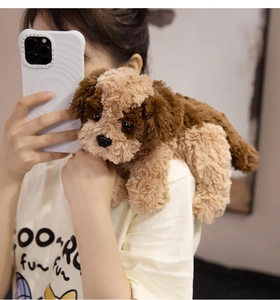 Detailed view of a soft brown plush dog toy being held to show size and fluffy texture