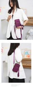 Close-up of purple quilted nylon crossbody phone bag with double zipper and adjustable strap