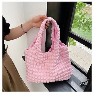Detailed close-up of pink puff tote bag showing bubbly textured fabric and double handles