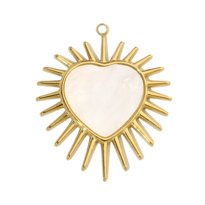 Macro detail of a heart-shaped pendant with gold radial metal and white shell inlay