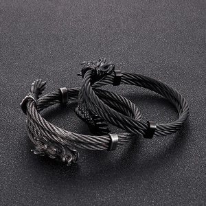 Detail of 8mm dragon head punk bracelets with woven steel cable in black and grey