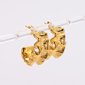 Irregular wavy leaf design earrings in 18k gold plated stainless steel on display