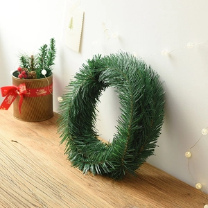 5.5m dense artificial pine Christmas garland on rustic wood surface with warm lights