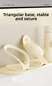 Detail of minimalist wave-shaped soap dishes with u-shaped tray in beige plastic
