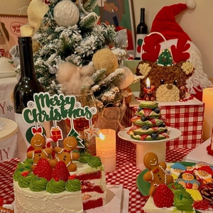 Close-up of Merry Christmas cake topper on red velvet cake with festive holiday treats