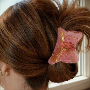 Pink translucent butterfly hair claw clip with golden glitter and resin material