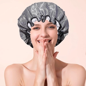 Elastic shower cap in black and white stripes with waterproof ruffle edge
