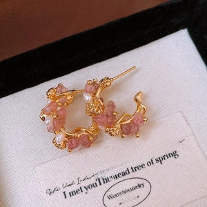 Macro view of 18k gold plated hoop earrings with pink strawberry quartz and pearls
