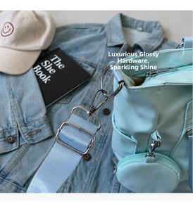 Close-up of baby blue Oxford tote with silver ring hardware and matching coin purse pouch
