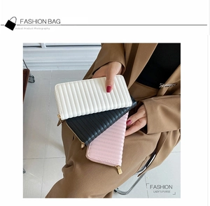 Three long PU leather quilted wallets in white, black, and pink with gold zippers