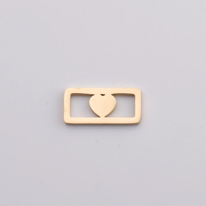 Detailed view of a gold rectangular pendant featuring a hollow heart-shaped cutout