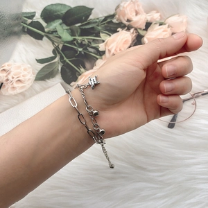 Elegant double-layer silver star bracelet with love you charm on a soft background