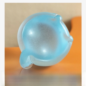 Close-up of the smooth stable base of a luminous cat figurine for micro landscapes