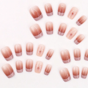 Pink and nude gradient French press-on nails with white floral patterns and glossy finish