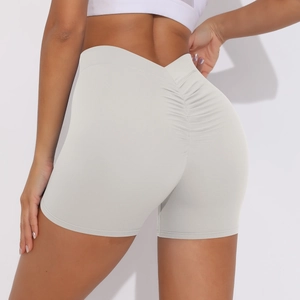 Detail of high waisted gray yoga shorts featuring peach lift scrunch seam for women