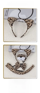 Detail view of 4-piece leopard print plush headband, bowtie, tail, and muzzle set
