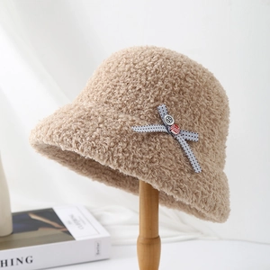 Detail of camel sherpa bucket hat with blue polka dot bow and textured fleece material