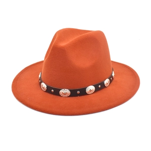 Detail of caramel wool felt fedora featuring black leather band with silver metal rivets