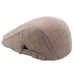 Detail of khaki herringbone beret with red-blue grid pattern and metal buckle