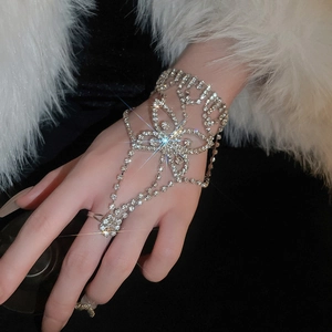 Detailed close-up of a silver butterfly slave bracelet with sparkling rhinestones on hand