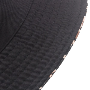 Black canvas bucket hat with parallel stitching and leopard print lining detail