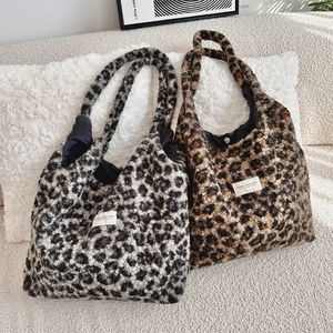 Detail of faux shearling leopard print tote bags with soft texture and magnetic closure