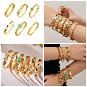 Detail view of 6-piece gold stainless steel bracelet set with turquoise and enamel